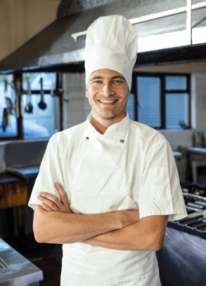 male-chef-standing-with-arms-crossed-in-kitchen-AGJHWSC